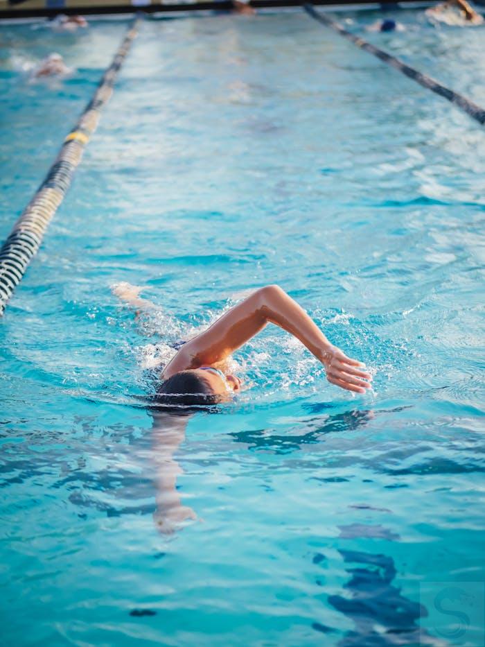 A Person Doing a Freestyle Swimming in the Pool